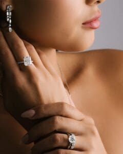 Close-Up Of A Woman Wearing Audrey Earrings, Josephine Ring, Angelica Ring, And Francesca Necklace From Square Accessories.