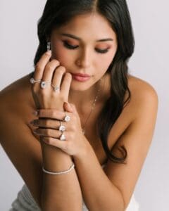 Model Is Wearing Louisa Round, Josephine, Faith, Sienna, Aurora, Aubrey Emerald, And Mira Jewellery Pieces.